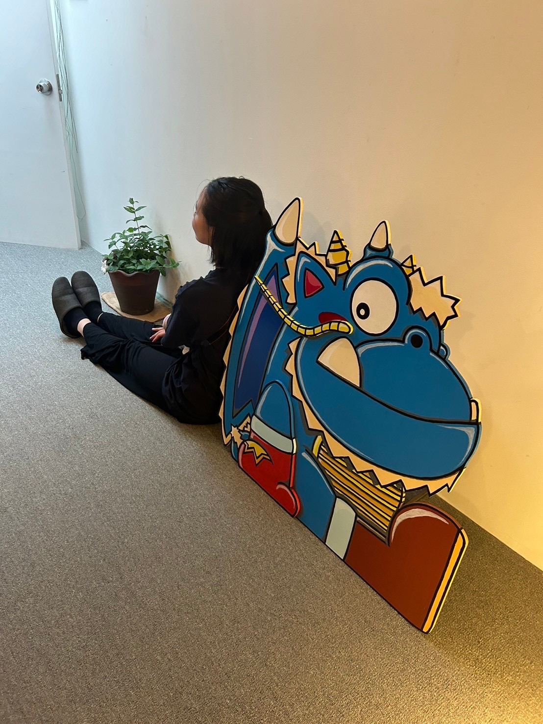 Person sitting next to colorful original illustration artwork